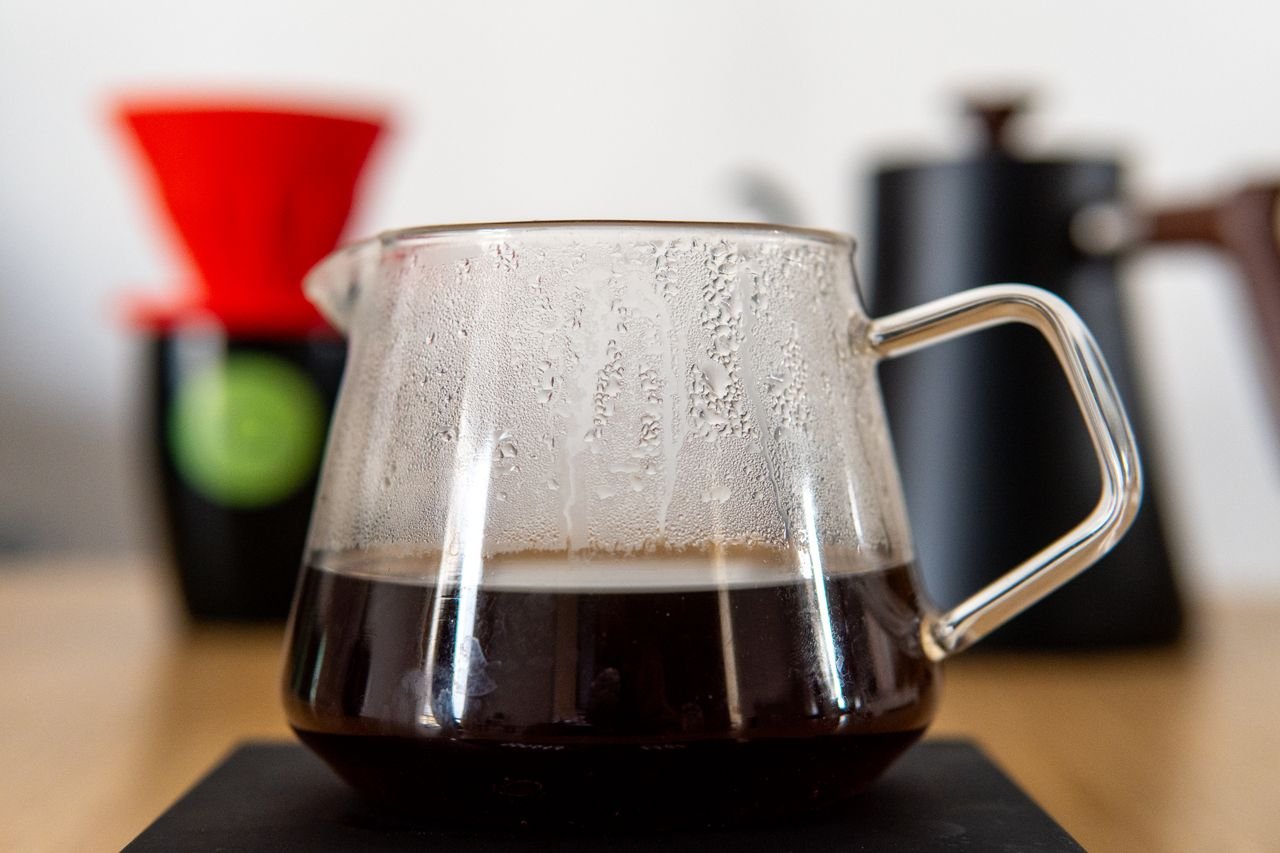 A glass carafe filled with freshly brewed specialty coffee using a V60 filter, perfect for coffee lovers.